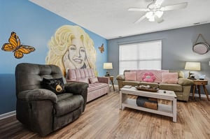 Relax in your whimsical living room featuring unique wall art, comfortable seating, and charming butterfly accents.