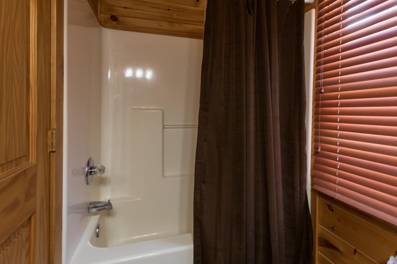 Bathroom with a tub and shower at Four Seasons Lodge, a 3bedroom cabin rental located in Pigeon Forge