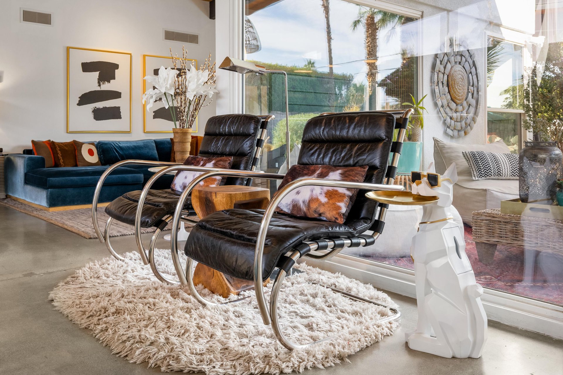 Sink into these luxurious leather chairs in your bright living space, where modern design meets comfort perfectly.