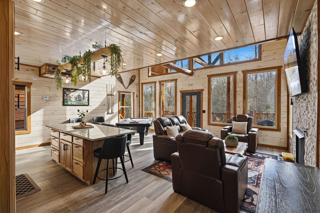 Cozy up in this stunning openconcept living space where rustic wood meets modern comfort, perfect for gathering with loved ones.