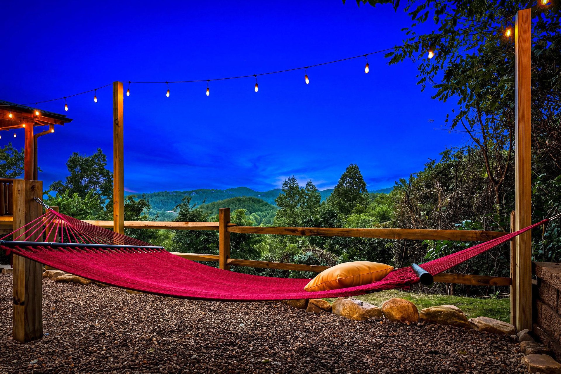 Unwind under the stars in your hammock as string lights glow softly overhead and mountain silhouettes frame the horizon. A perfect spot to let the day melt away.