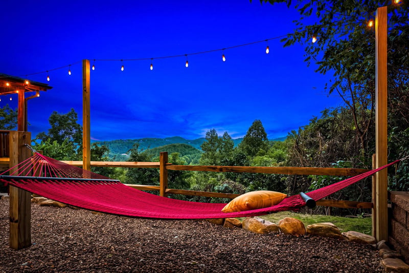 Unwind under the stars in your hammock as string lights glow softly overhead and mountain silhouettes frame the horizon. A perfect spot to let the day melt away.