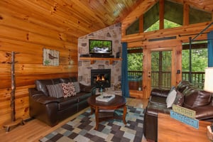 Living room with a fireplace and TV at Kellys Cabin, a 1 bedroom cabin rental located in Pigeon Forge