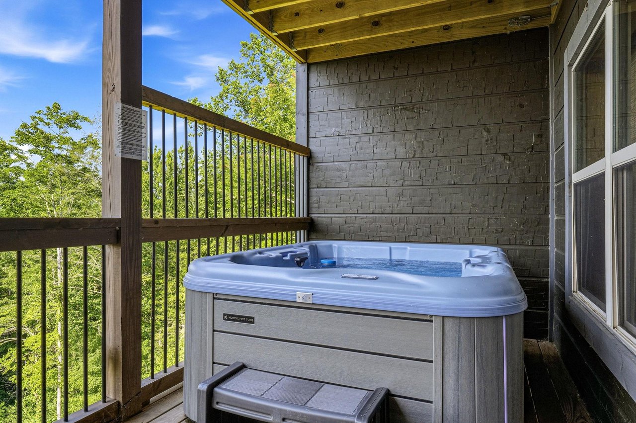Soak away the day in your private hot tub, surrounded by lush greenery and open skies from this peaceful covered balcony.