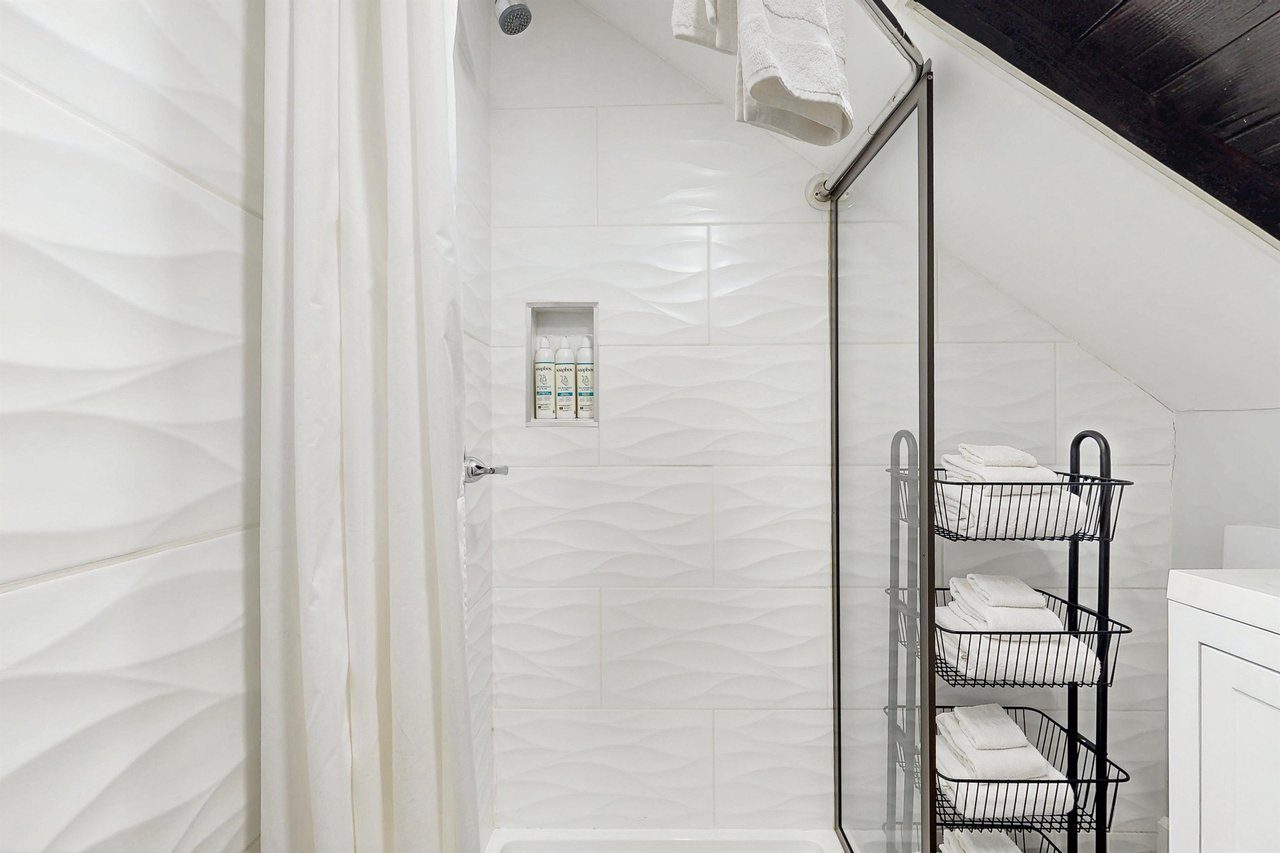 Ensuite primary bathroom with stand alone shower.