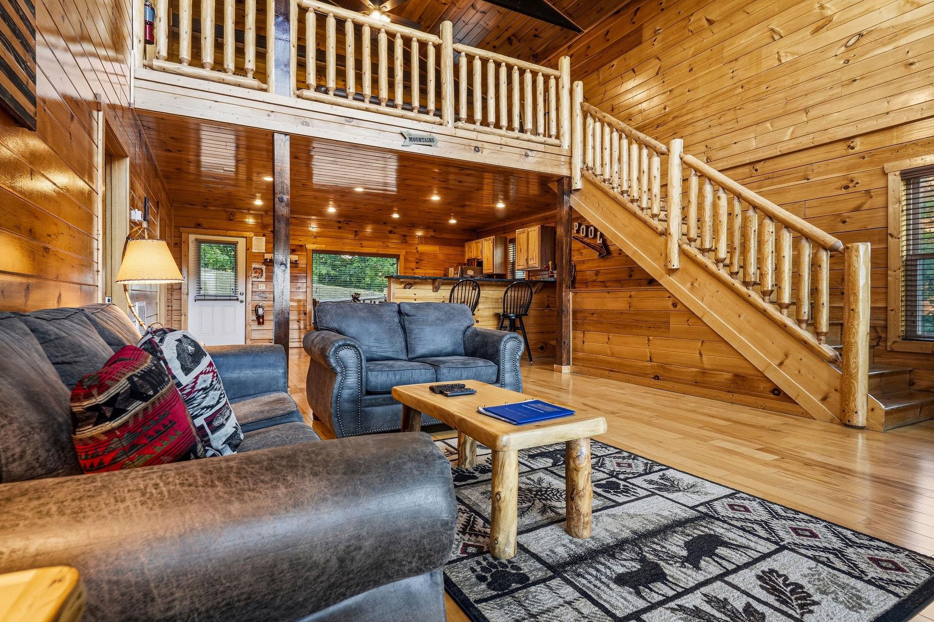 Unwind in your private cabins inviting living room, where rustic wood beams and soaring ceilings create a cozy mountain retreat youll love returning to after a day of adventure.