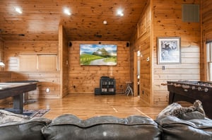 Settle into your private game room with warm knotty pine walls, a bigscreen TV for movie nights, air hockey, and foosball—your perfect space to unwind and compete.