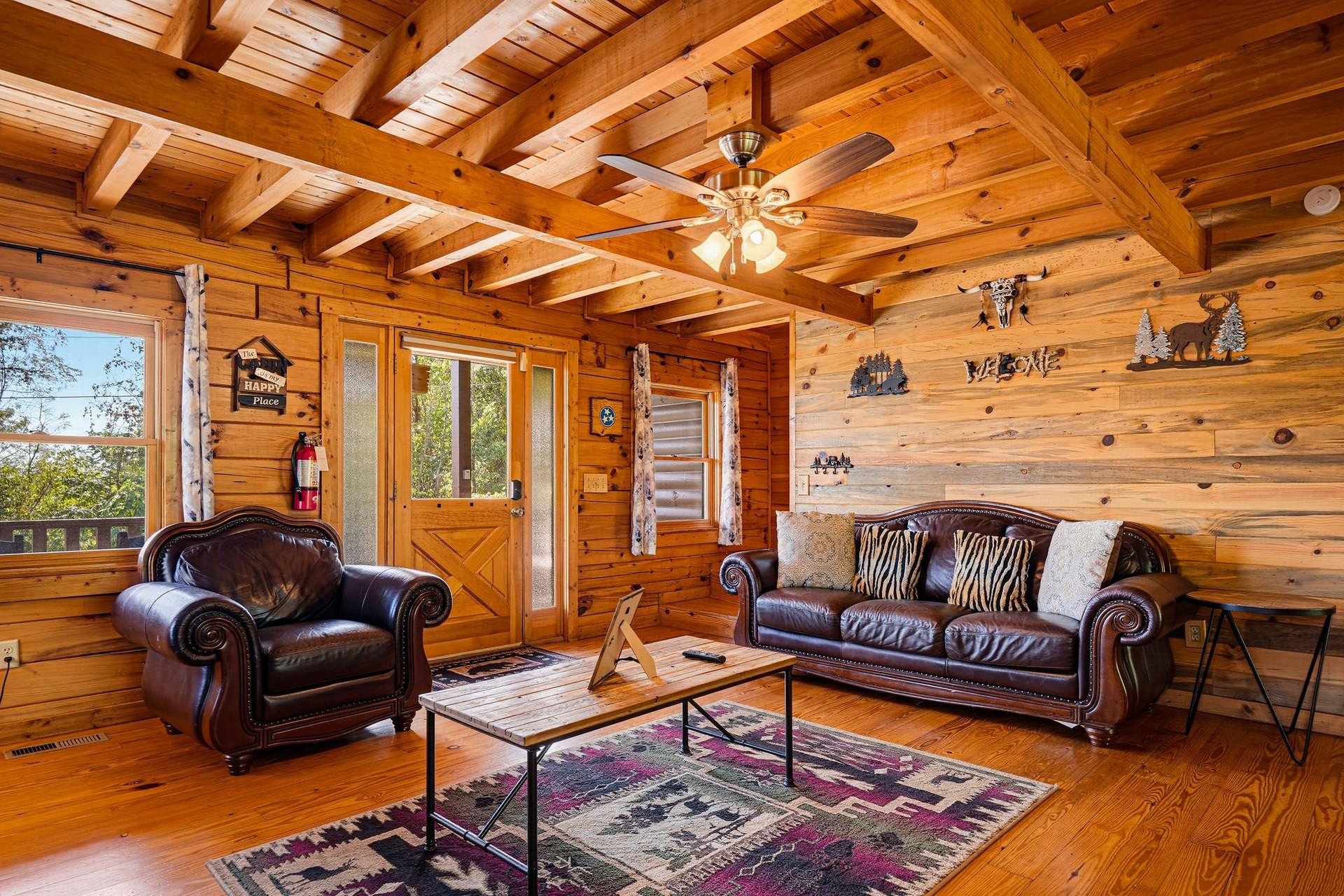 Relax in your warm, rustic living room with soaring wood beam ceilings and rich leather seating that invite you to unwind after a day of mountain adventure.