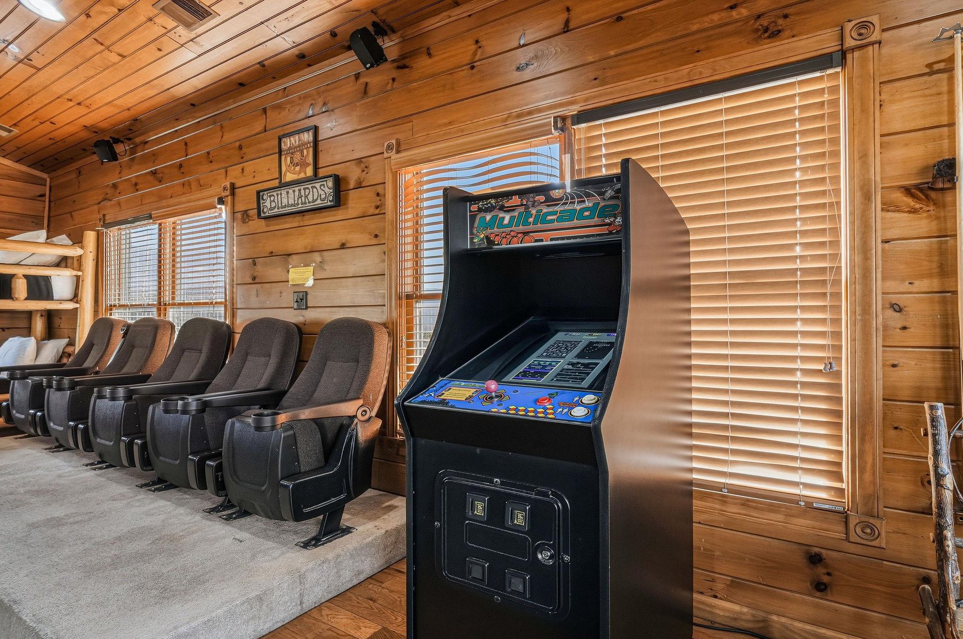Challenge friends to classic arcade games in your private theaterstyle game room, where rustic wood walls meet retro entertainment for unforgettable group fun.