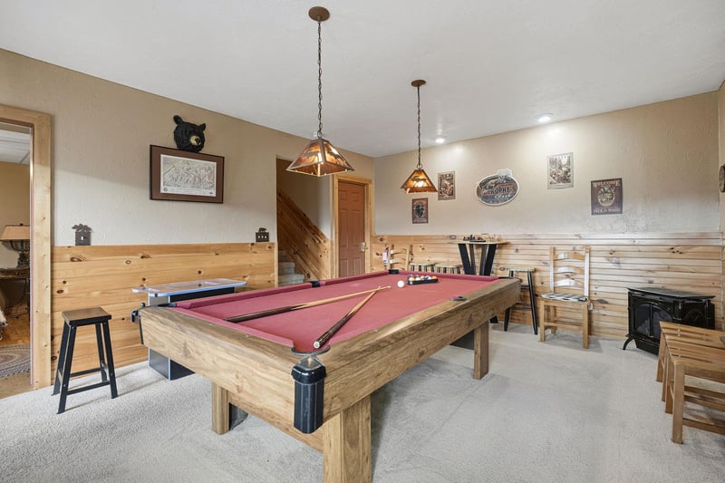 Challenge your friends to a game in this cozy recreation room, featuring rustic wood accents and mountainthemed decor for perfect aprèsski entertainment.