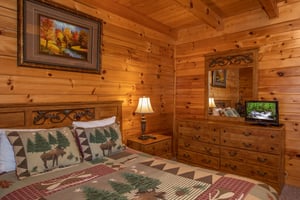 Dresser, mirror, and TV in a bedroom at Momma Bear, a 2 bedroom cabin rental located in Pigeon Forge