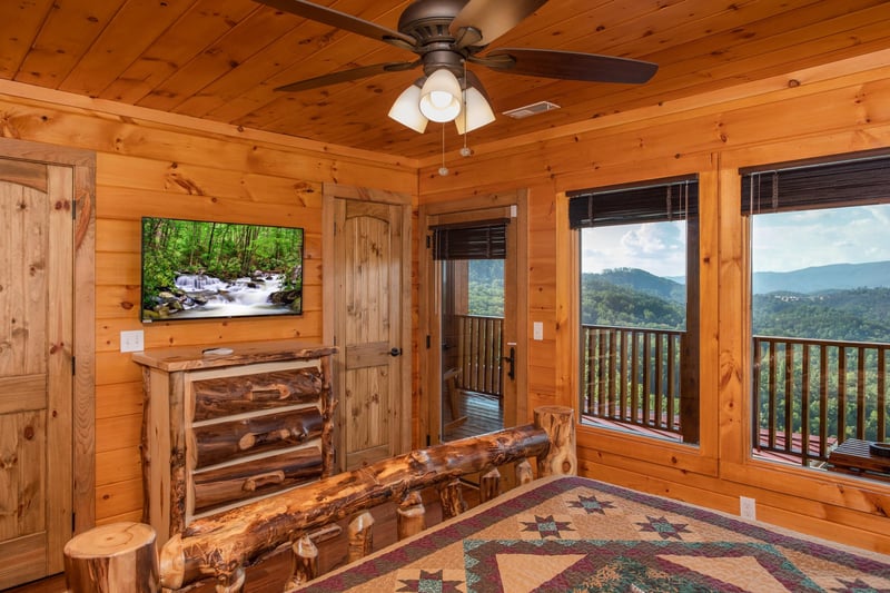 Queen Bedroom with a TV, Dresser, Deck access, with Mountain Views