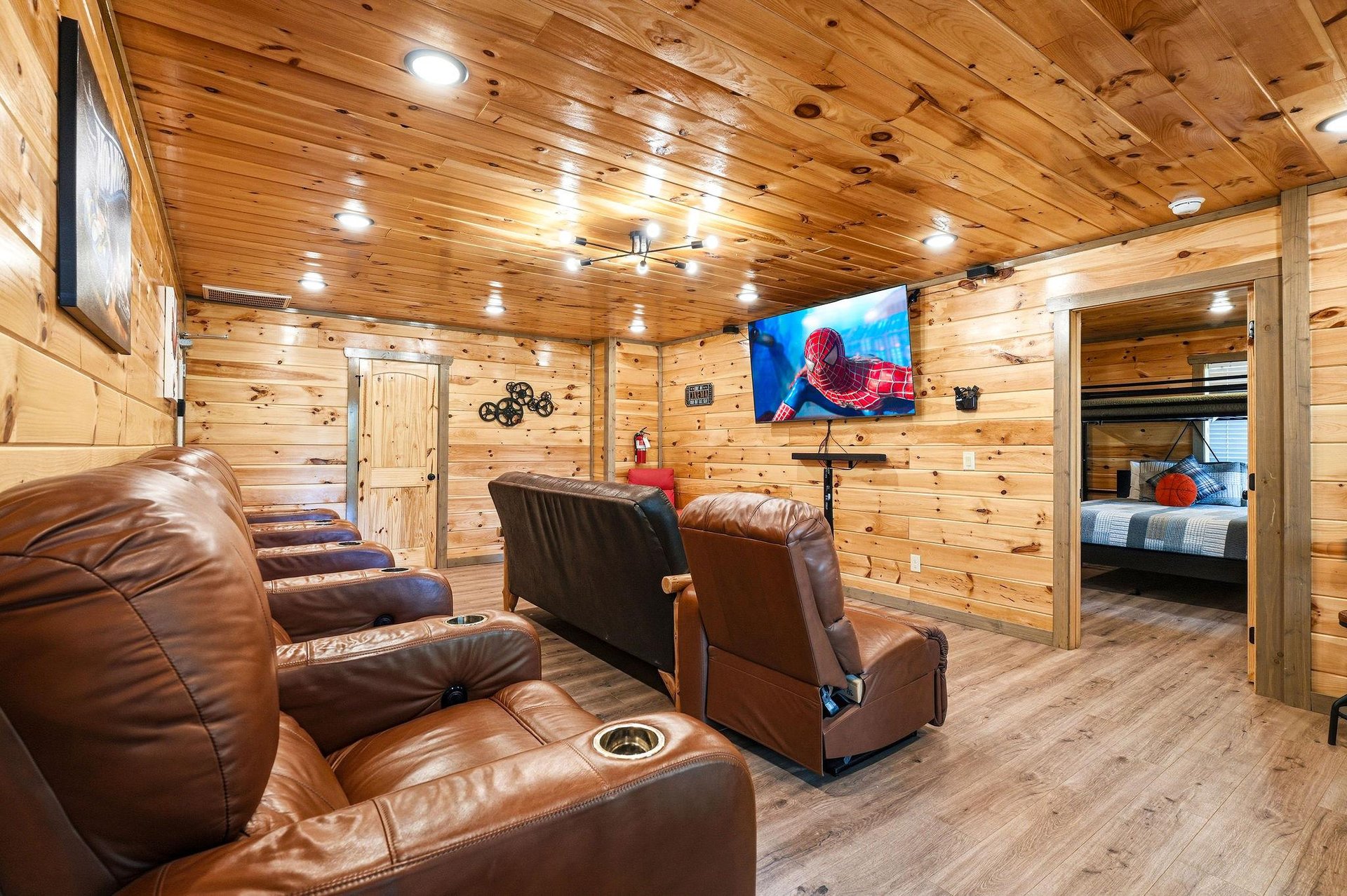 Sink into plush leather recliners for your private movie night in this cozy woodpaneled theater room with surround sound.