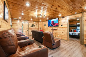 Sink into plush leather recliners for your private movie night in this cozy woodpaneled theater room with surround sound.