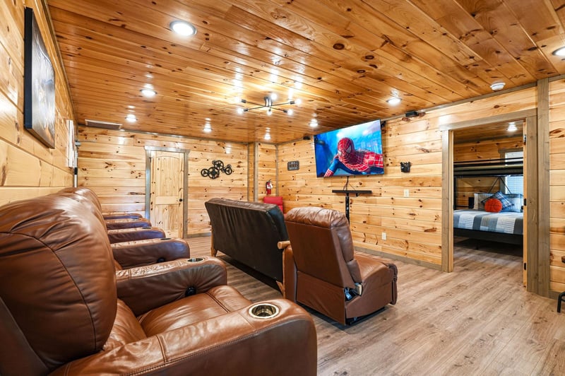 Sink into plush leather recliners for your private movie night in this cozy woodpaneled theater room with surround sound.