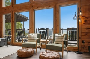 Sink into cozy seating as you soak in breathtaking mountain views through soaring windows. The warm wood walls and stylish decor create your perfect retreat for relaxation.