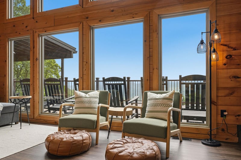 Sink into cozy seating as you soak in breathtaking mountain views through soaring windows. The warm wood walls and stylish decor create your perfect retreat for relaxation.