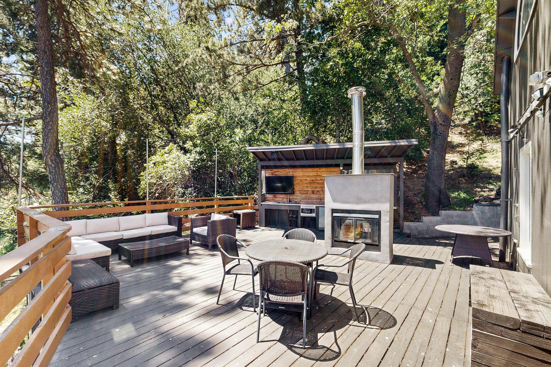 The deck area is perfect for entertaining with a wet bar, outdoor seating, and an outdoor fireplace.