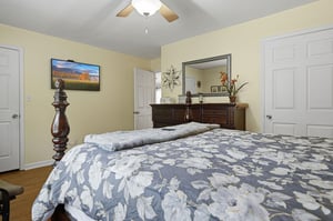 Settle into your cozy bedroom with elegant furnishings, a wallmounted TV for your entertainment, and soft linens awaiting your arrival after a day of adventure.