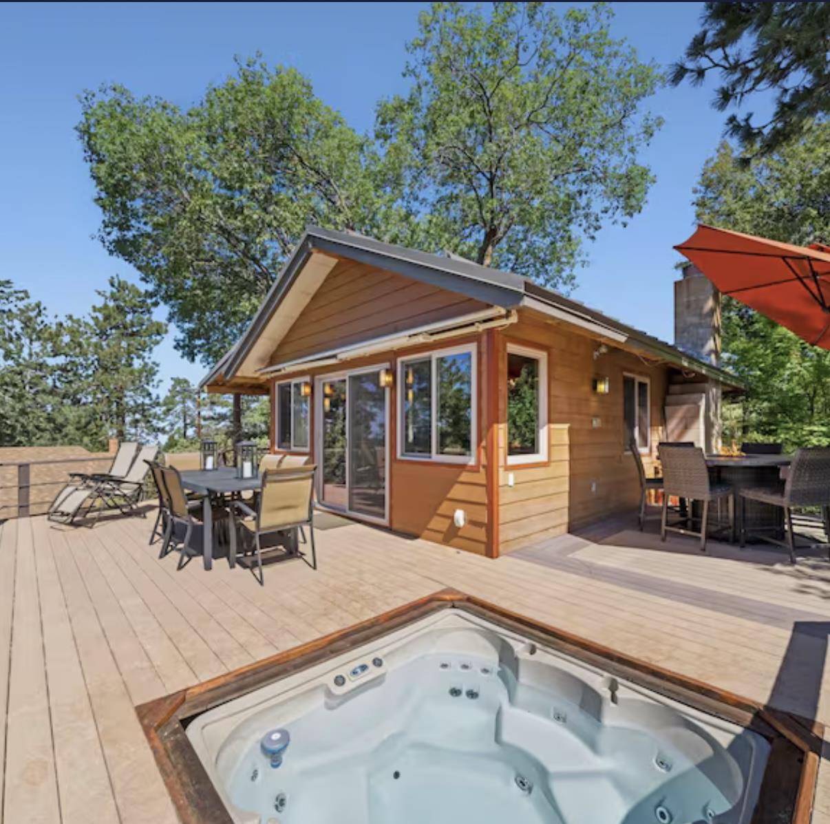 Private hot tub overlooking expansive mountain views, spacious deck, outdoor seating and dining, fire pit, koi pond, and fenced yard for dogs.