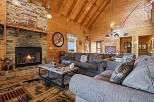 Settle into plush sofas beneath soaring wood beams and let the crackling stone fireplace warm your mountain getaway.
