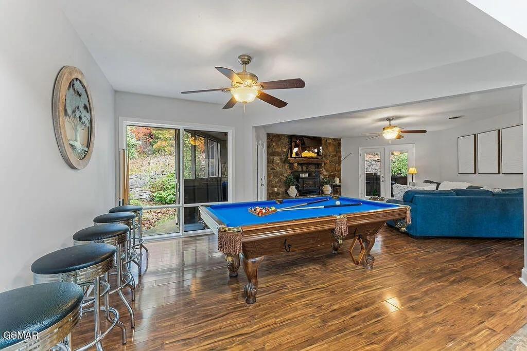 Your game room awaits with a fullsize billiards table, cozy fireplace, and bar seating for entertaining friends and family.