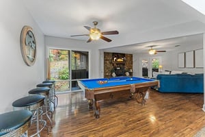 Your game room awaits with a fullsize billiards table, cozy fireplace, and bar seating for entertaining friends and family.