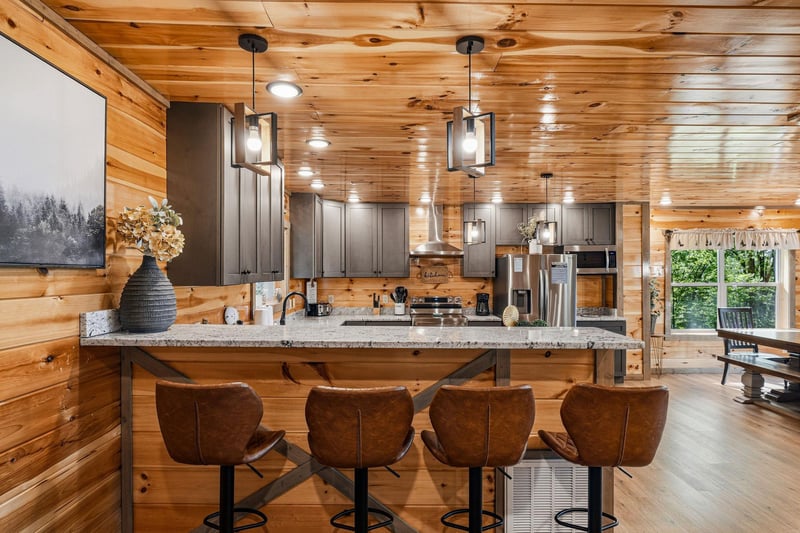 Your rustic kitchen awaits with modern appliances, granite counters, and cozy seating where youll gather for morning coffee and evening conversations.