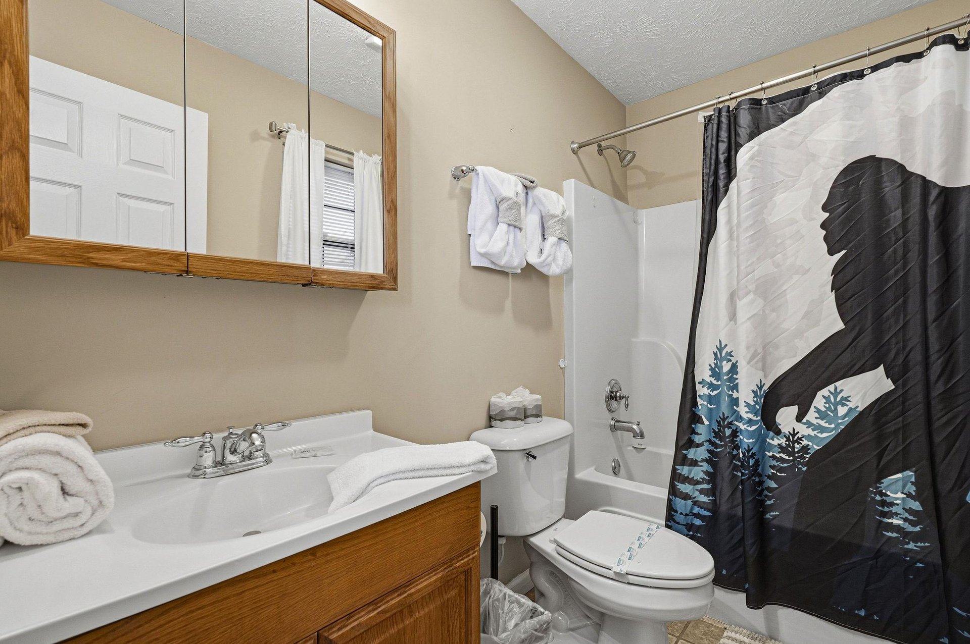 Step into your private bathroom featuring fresh towels and a relaxing tubshower combo for unwinding after mountain adventures.