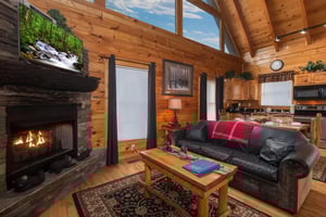 Living room with fireplace and TV at Country Bears Getaway, a 3bedroom cabin rental located in Gatlinburg