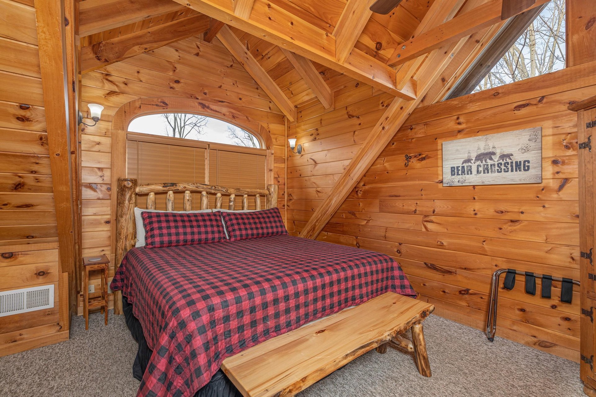 Loft with king bed, bench, and luggage rack at Livin Simple, a 2 bedroom cabin rental located in Pigeon Forge