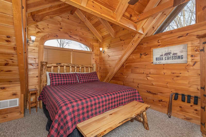 Loft with king bed, bench, and luggage rack at Livin Simple, a 2 bedroom cabin rental located in Pigeon Forge
