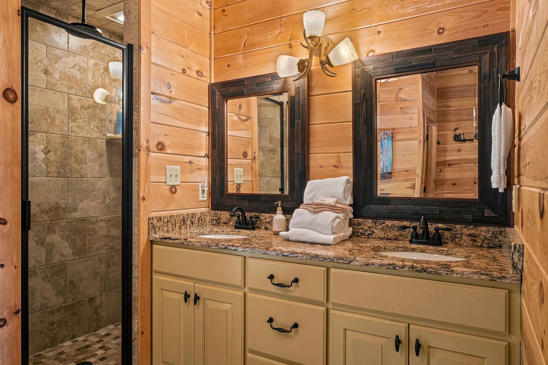 Unwind in your private bathroom with warm wood finishes, granite counters, and a spacious stonetiled shower—perfect for refreshing after a day of adventure.