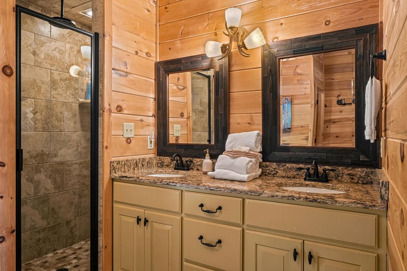 Unwind in your private bathroom with warm wood finishes, granite counters, and a spacious stonetiled shower—perfect for refreshing after a day of adventure.