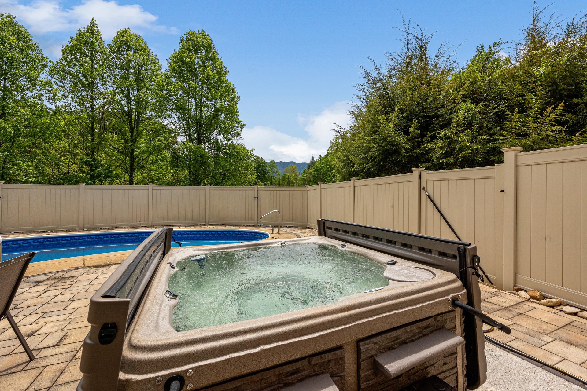 Soak your cares away in the bubbling hot tub, with scenic mountain and forest views beyond the private fenced patio—your perfect outdoor retreat.