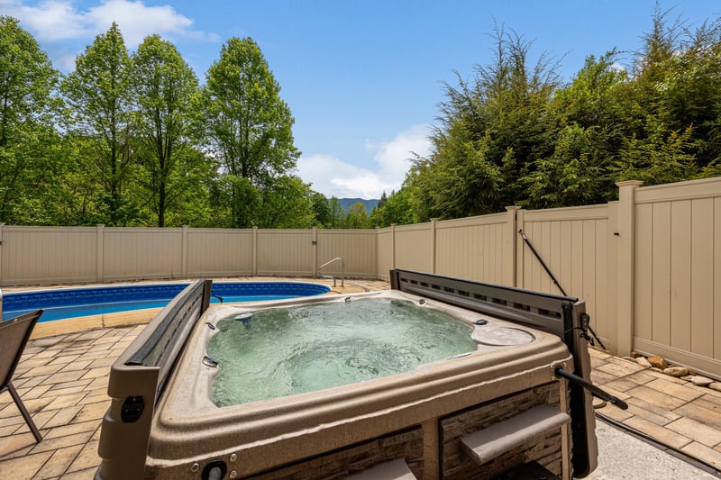 Soak your cares away in the bubbling hot tub, with scenic mountain and forest views beyond the private fenced patio—your perfect outdoor retreat.