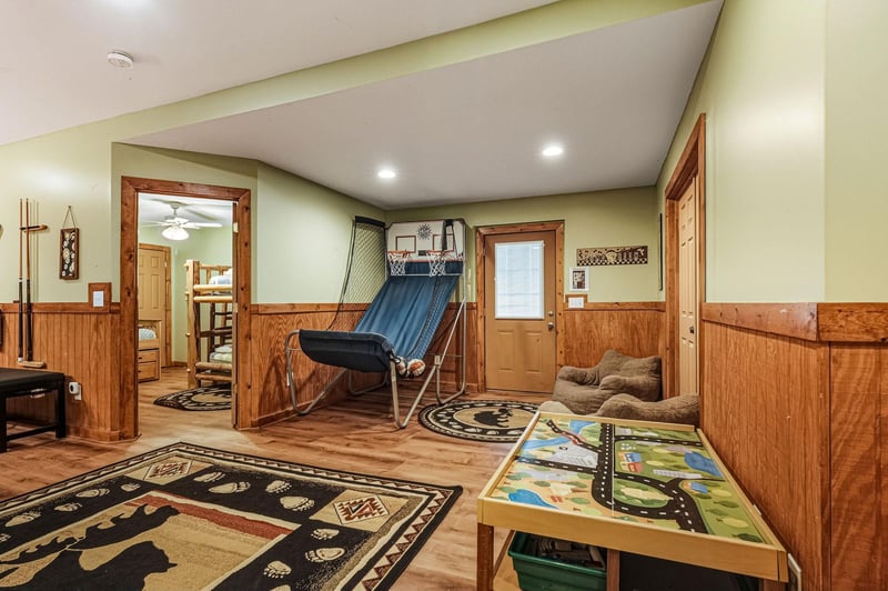 Your private game room awaits with basketball hoops, pool cues, and cozy seating for endless entertainment.