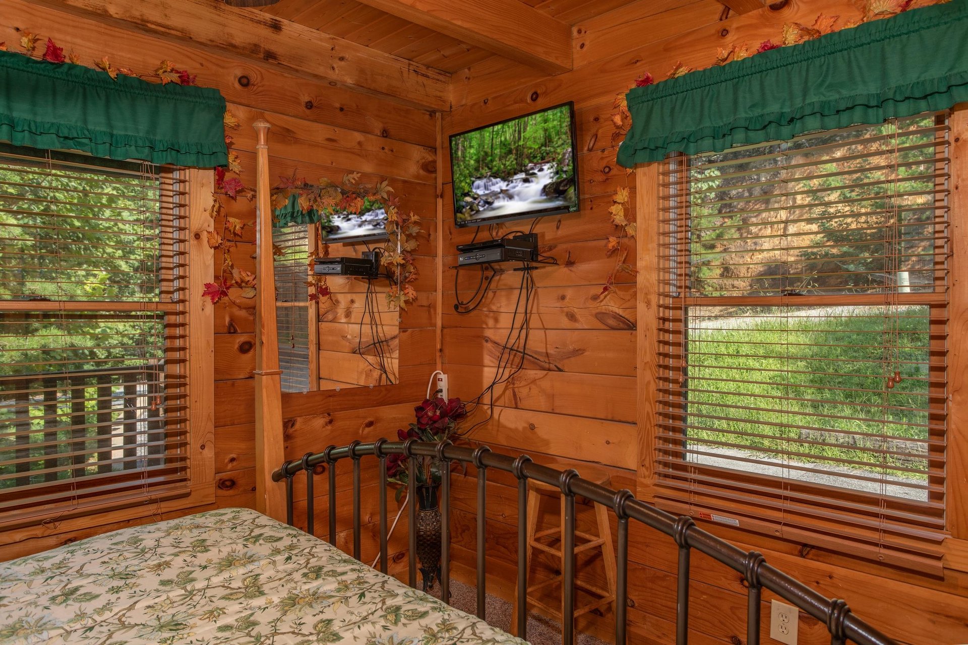 bedroom with wall mounted television at angels majestic view a 3 bedroom cabin rental located in pigeon forge