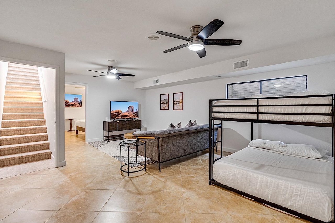 Basement living room with queen over queen bunkbeds