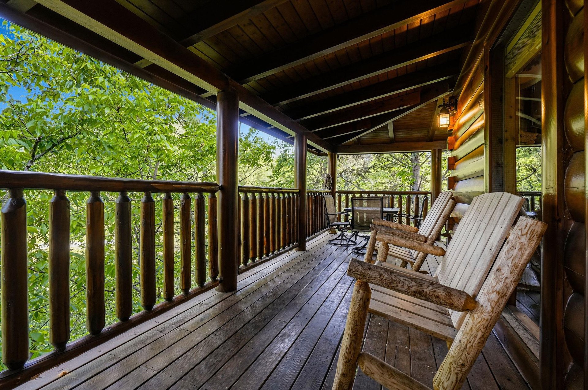 Unwind on your private covered deck with handcrafted log chairs, surrounded by lush forest views that create the perfect mountain retreat escape.