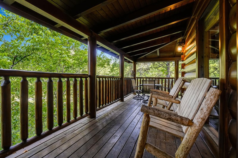 Unwind on your private covered deck with handcrafted log chairs, surrounded by lush forest views that create the perfect mountain retreat escape.