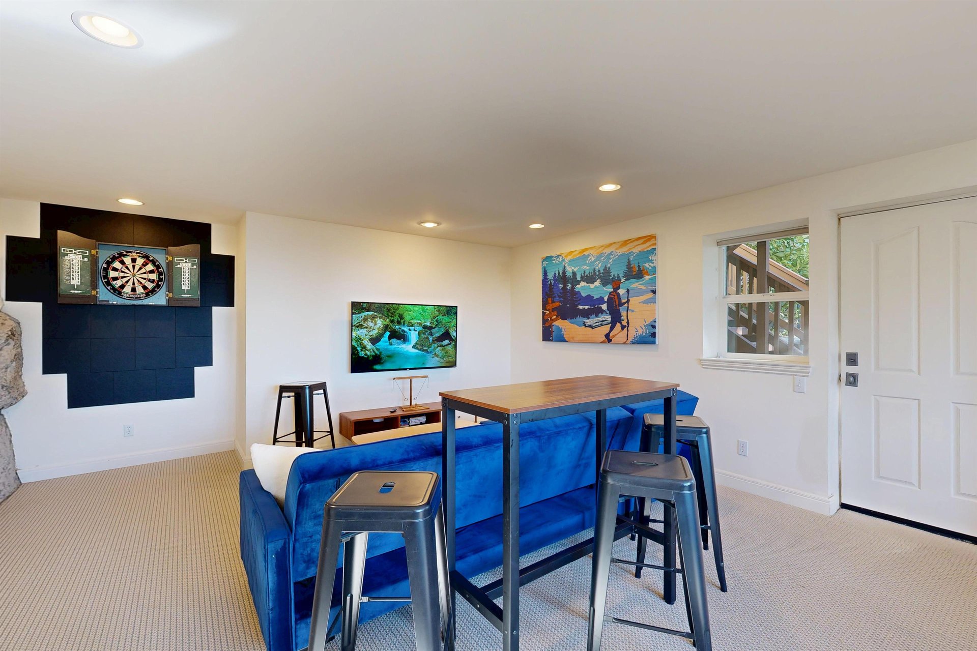Smart TV, shuffleboard, darts, deck access, and a sofa pullout twin bed.