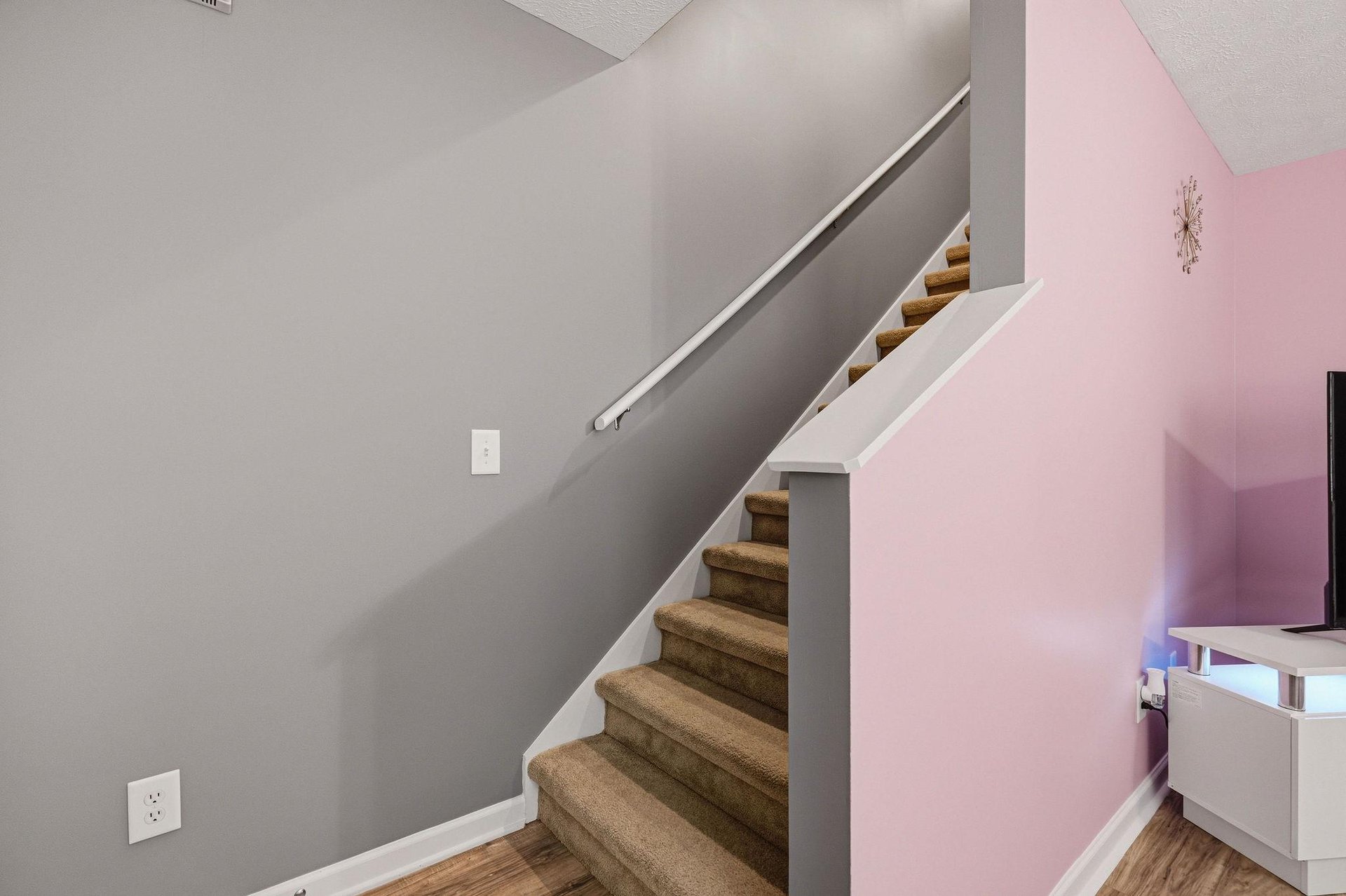 Your stylish stairway features soft LED lighting and modern design, creating a welcoming path to your private retreat upstairs.