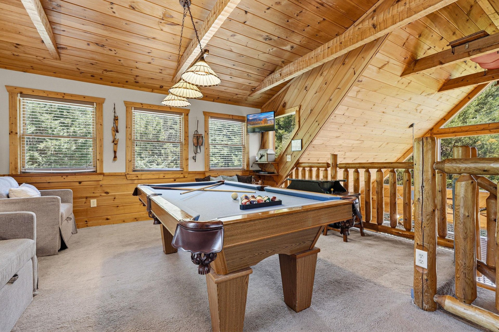 Your very own game loft awaits—sink into the warmth of pine beams, challenge friends to a match at the billiard table, and let the mountain air drift through the windows.