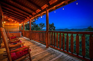 Sink into your rocking chair as twilight falls over the mountains. The hot tub beckons under a canopy of string lights, with forest views stretching endlessly before you.