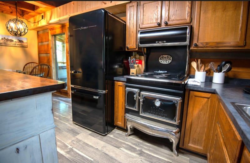 Your charming kitchen features vintagestyle appliances and warm wood cabinets, creating the perfect space for cooking memorable meals together.
