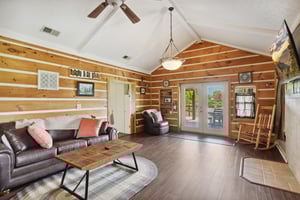 living room with sofa bed and balcony access