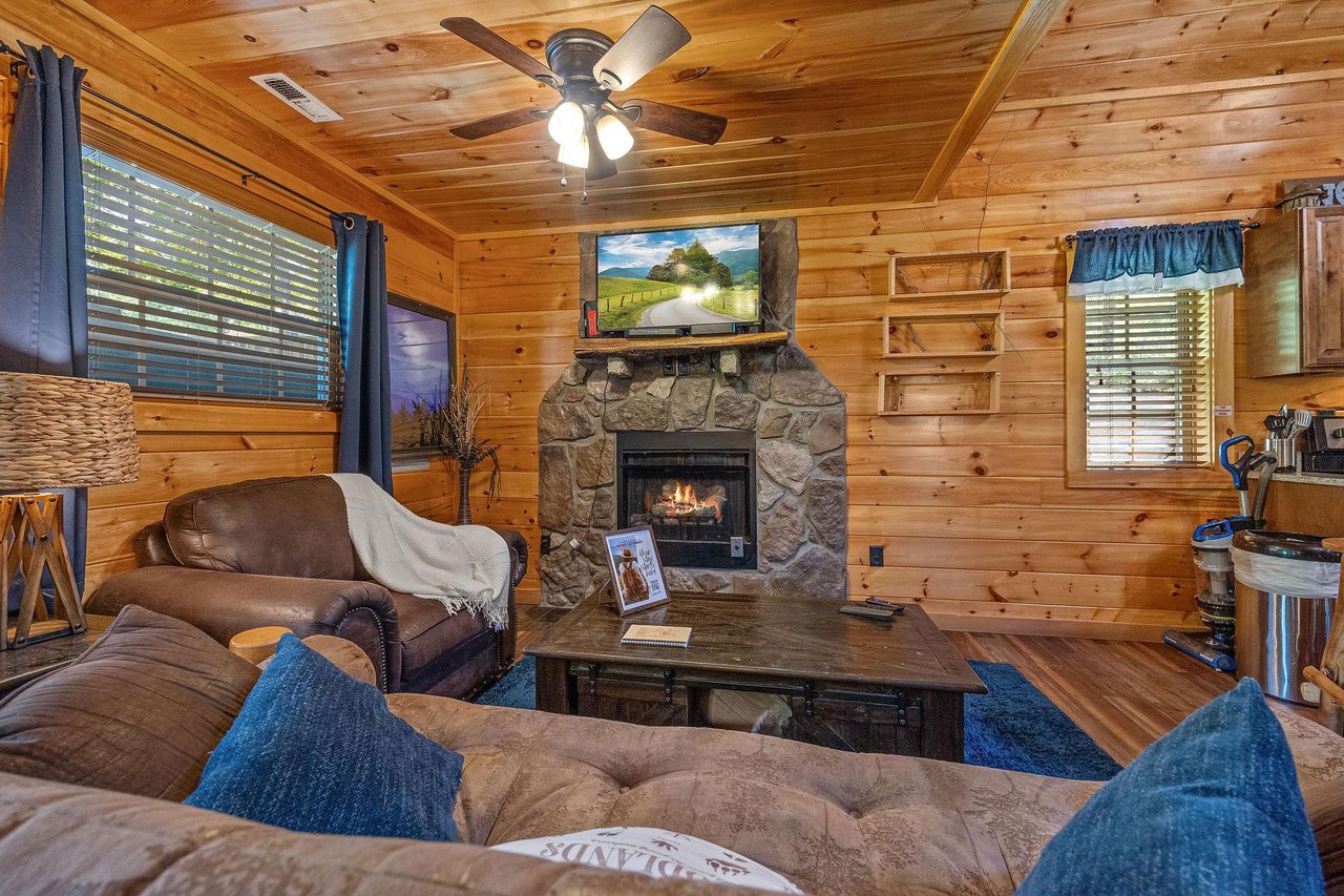 Living room area with stone fireplace