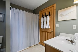 Step into your private bathroom retreat with plush towels, charming rustic touches, and everything you need for a refreshing mountain getaway.