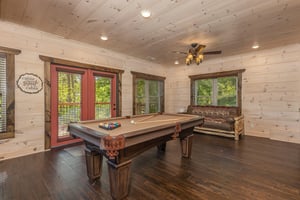 Challenge friends to a game in your private billiards room, where rustic charm meets entertainment beneath soaring woodpaneled ceilings.